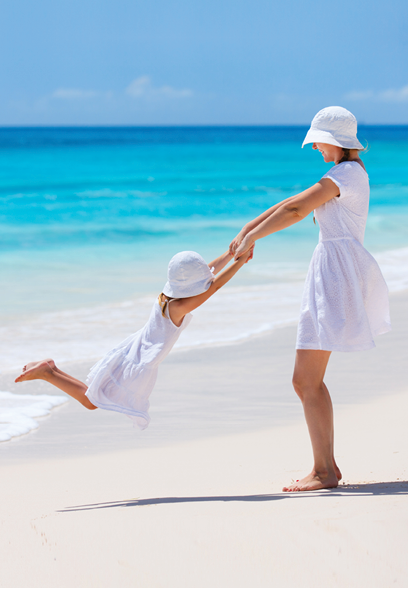 Mother and daughter having fun at tropical beach