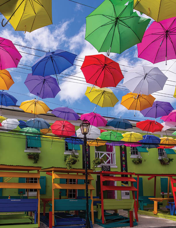 Nassau, Bahamas - May 30, 2019: Colorful umbrellas shading the tourist precinct of West Hill St in Nassau city, with its art galleries, cafes and Graycliff Hotel.