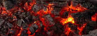 Burning coals from a fire abstract background.