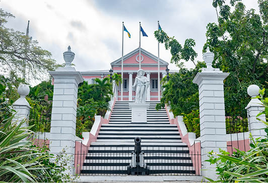 Nassau, Bahamas - December 02 2015: The Government House in Nassau, Bahamas, painted in pink, with statue of Christopher Columbus on the staircase