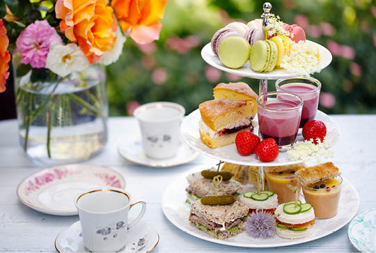 Traditional english afternoon tea with cakes and sandwiches