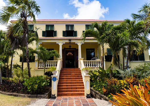 Sunbury, Barbados -2022: Sunbury Plantation House. Restored great house from gentry time of sugar barons. Built in 1600s by Matthew Chapman an early settler. Front exterior, porch, jalousie shutters.