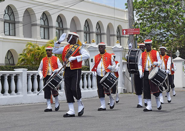 Bridgetown, Saint Michael, Barbados. March 22, 2018. Changing of the guard outside historic garrison. Sargeant major gives salute with drummers in background. Arches of former British garrison visible