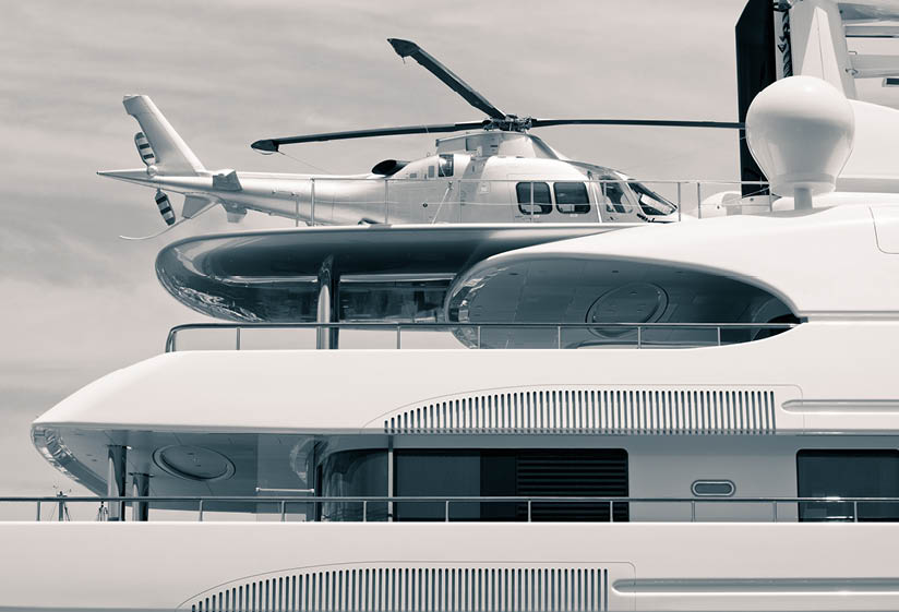 Luxury yacht with helicopter on the deck, digitally retouched and toned photo.