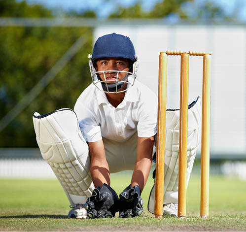 Cricket, sports and a man as wicket keeper on a pitch for training, game or competition. Male athlete behind stumps with gear for action, playing professional sport and exercise for fitness or mockup.