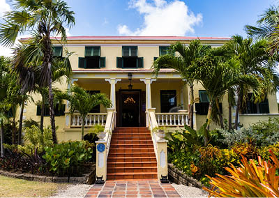 Sunbury, Barbados -2022: Sunbury Plantation House. Restored great house from gentry time of sugar barons. Built in 1600s by Matthew Chapman an early settler. Front exterior, porch, jalousie shutters.