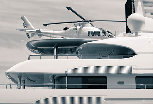 Luxury yacht with helicopter on the deck, digitally retouched and toned photo.