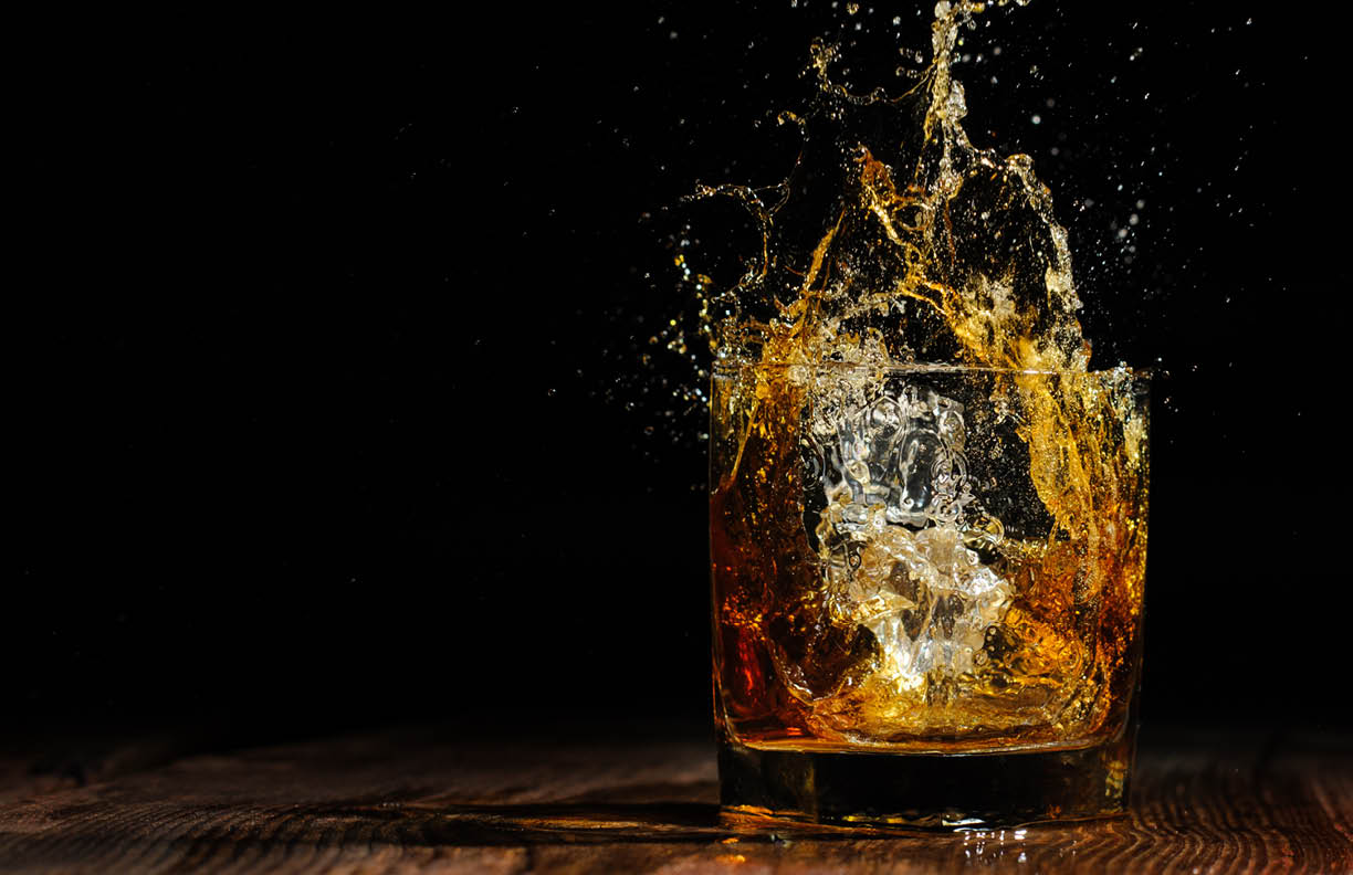 glass with cognac on the wooden table