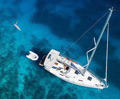 amazing view to yacht, swimming woman and clear water - caribbean paradise