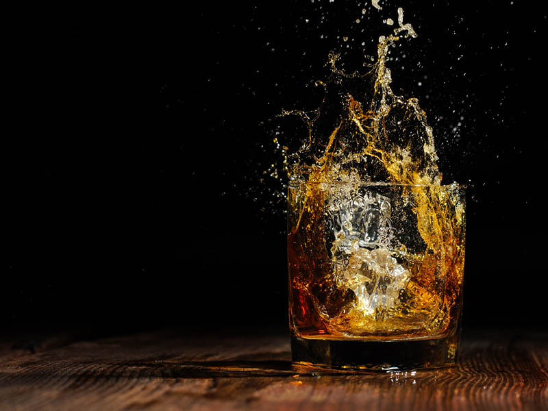 glass with cognac on the wooden table