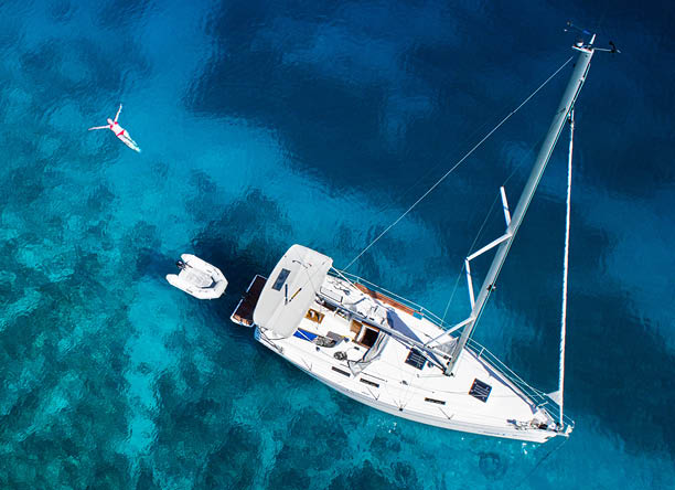 amazing view to yacht, swimming woman and clear water - caribbean paradise
