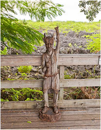 GRAND CAYMAN ISLAND - SEPTEMBER 29, 2015: Wooden statue of a devil in place called The Hell in Grand Cayman. The Hell is a group of short, black, limestone formations, popular tourist attraction 