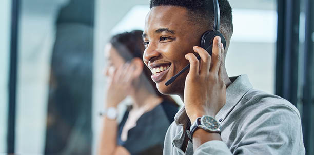 Shot of a young call centre agent on a call in an office.