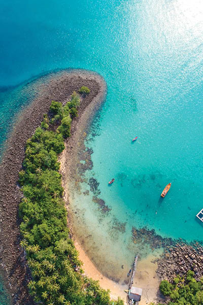 Amazing island with sand beach green tree forest aerial view blue sea water