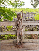 GRAND CAYMAN ISLAND - SEPTEMBER 29, 2015: Wooden statue of a devil in place called The Hell in Grand Cayman. The Hell is a group of short, black, limestone formations, popular tourist attraction 