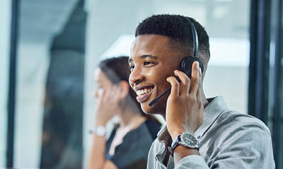 Shot of a young call centre agent on a call in an office.