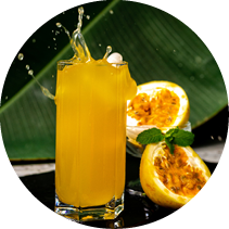 Glass of passionfruit juice with a splash and a fruit cut in half
