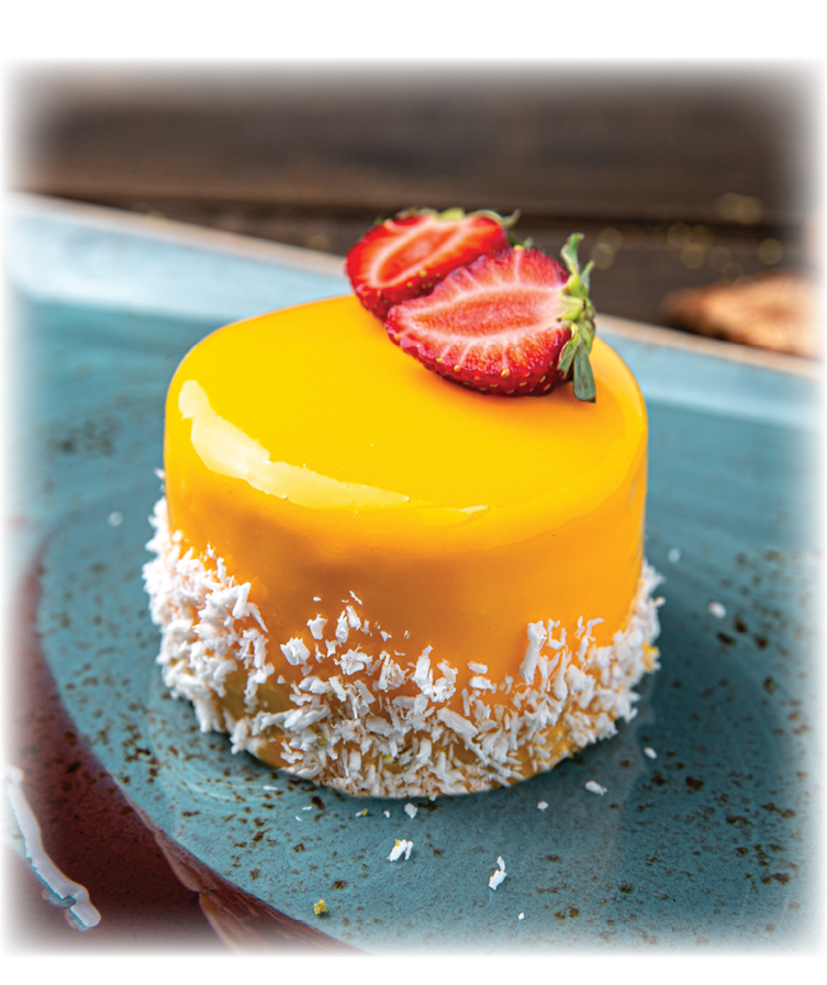 Dessert soft mango mousse or peach and strawberry. Menu for a restaurant. Beautiful composition on wooden boards.