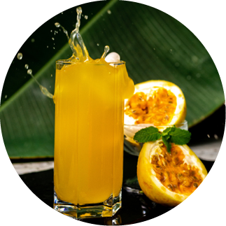 Glass of passionfruit juice with a splash and a fruit cut in half