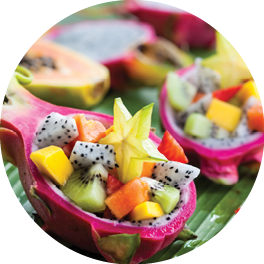 Exotic fruit salad served in half a dragon fruit