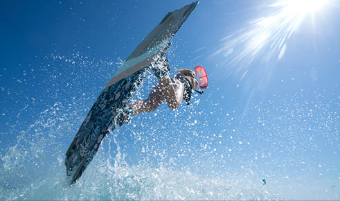 Kite girl rides in the ocean clear water