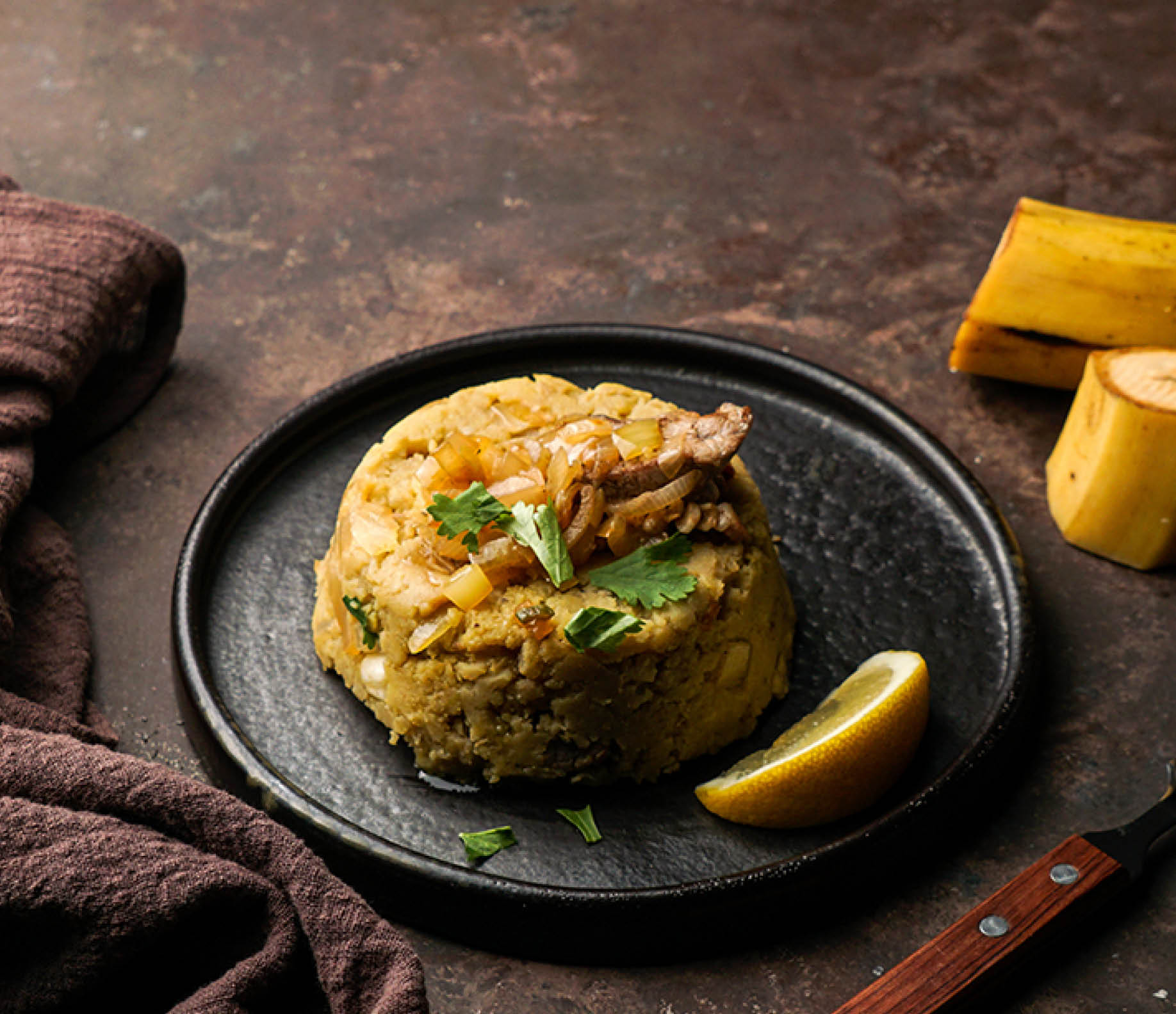 mashed boiled plantains with pork meat, onion. Puerto Rico.  Amazonian cuisine, Peru, Cuba