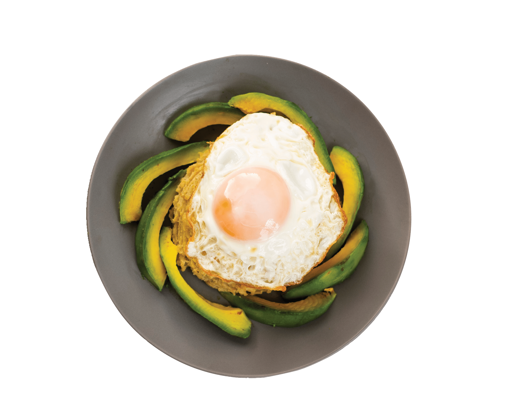 Green plantains mashed with fried egg and avocado, on wooden table. Delicious Mangu traditional Dominican food.