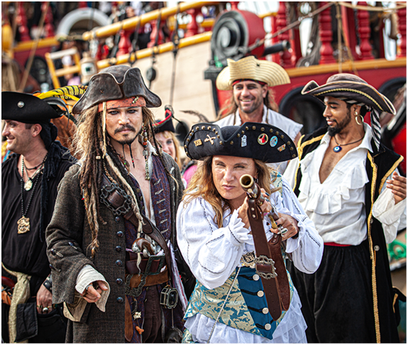 Johnny Depp Lookalike, Jolly Roger Pirate ship. men women dressed as pirate sword fighting,  Pirates Week 2012 from 8 to 18 November on November 10 2017 in Georgetown Cayman Island. Caribbean