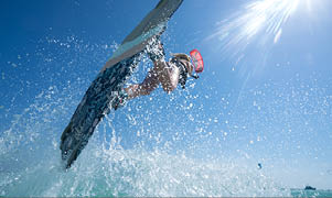 Kite girl rides in the ocean clear water