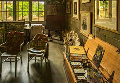 Fort Lauderdale, FL - US - Feb 7, 2024 View of large windows allowing natural light to shine in on easels, worktables and art supplies of the Bonnet House Museum and garden’s Art Studio.