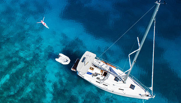 amazing view to yacht, swimming woman and clear water - caribbean paradise