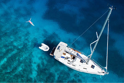amazing view to yacht, swimming woman and clear water - caribbean paradise