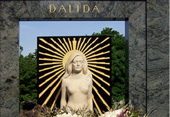 PARIS, FRANCE - MAY 09, 2023: Montmartre Cemetery in Paris, Dalida famous French singer and actress grave, monument with beautiful white flower bouquets, tourist attraction