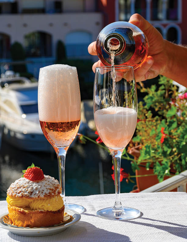 Summer party, drinking of French brut rose champagne sparkling wine in glasses in yacht harbour of Port Grimaud near Saint-Tropez, French Riviera vacation, Var, France