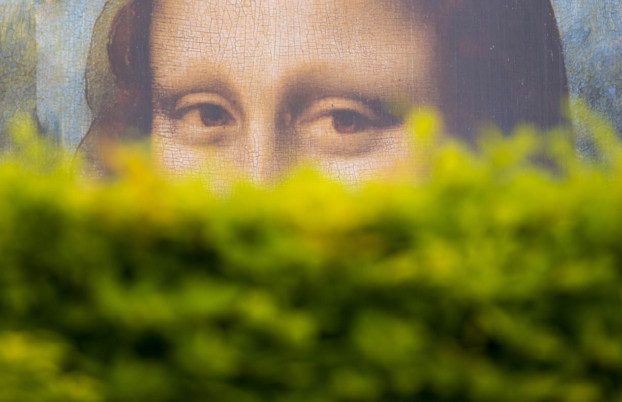 PARIS - MAY 07: Mona Lisa's look behind of the bushes, a large billboard in the garden of Tuileries Garden on May 07. 2017 in Paris