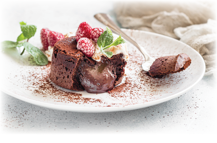 Delicious chocolate fondant or lava cake with cream, raspberries and mint, light grey concrete background. Hot chocolate dessert (pudding) with liquid center. Fondant au chocolate. 