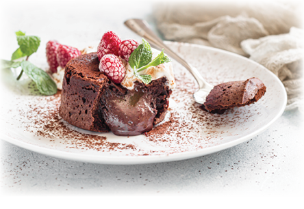 Delicious chocolate fondant or lava cake with cream, raspberries and mint, light grey concrete background. Hot chocolate dessert (pudding) with liquid center. Fondant au chocolate. 