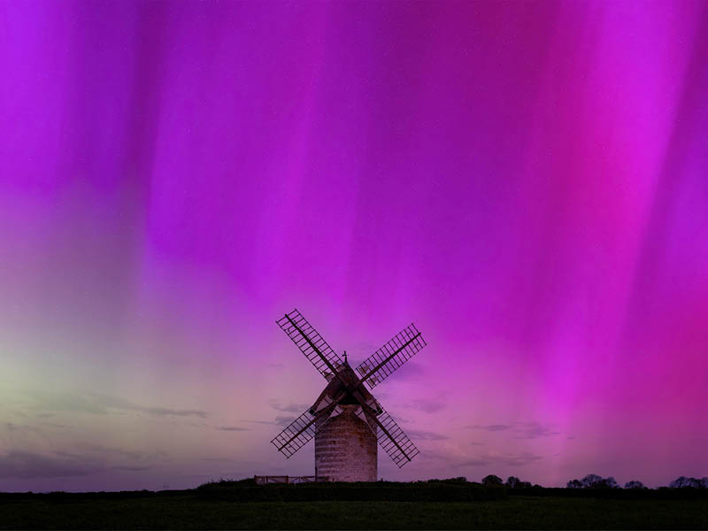 Northern lights in Normandy, France, Hauville stone windmill (Moulin de Pierre) and countryside