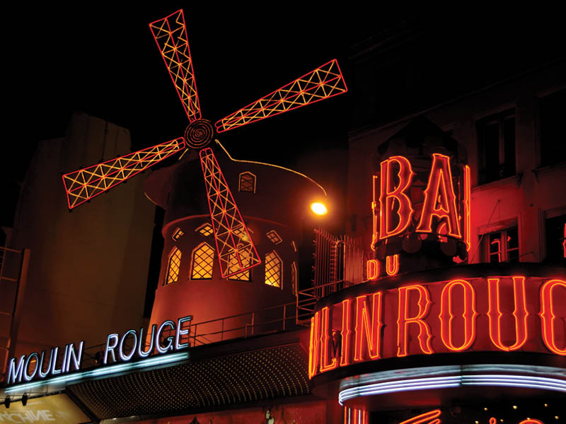 Paris, France - November 26, 2011: Moulin Rouge entrance in Paris. The Moulin Rouge is world famous for it's burlesque shows and has even featured in it's own movie.