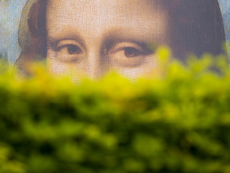 PARIS - MAY 07: Mona Lisa's look behind of the bushes, a large billboard in the garden of Tuileries Garden on May 07. 2017 in Paris