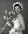 Beautiful 1950's Dior model with white dress holding flowers
