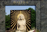 PARIS, FRANCE - MAY 09, 2023: Montmartre Cemetery in Paris, Dalida famous French singer and actress grave, monument with beautiful white flower bouquets, tourist attraction