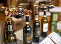 Montepulciano, Tuscany, Italy.August 2021. Close up shot of bottles with cruet for tasting in a typical local wine shop.
