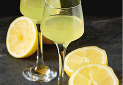 Traditional Italian acoustical leker. Lemonchello of lemons. Dark background