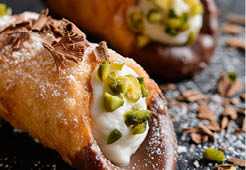 Cannoli Siciliani - traditional dessert stuffed with ricotta cream and pistachios