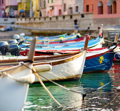 Colourful fishing boats in small marina of Vernazza, one of the five centuries-old villages of Cinque Terre, located on rugged northwest coast of Italian Riviera, Liguria, Italy.