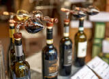 Montepulciano, Tuscany, Italy.August 2021. Close up shot of bottles with cruet for tasting in a typical local wine shop.