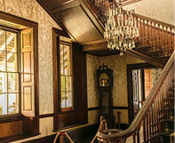 Montego Bay, Jamaica - June 05 2015: Staircase, chandelier and grandfather clock inside the Rose Hall Great House in Montego Bay.