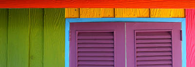 Beach style Caribbean house painted with primary colors in reggae decorative style