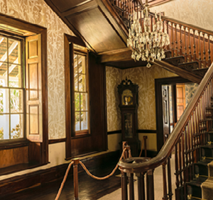 Montego Bay, Jamaica - June 05 2015: Staircase, chandelier and grandfather clock inside the Rose Hall Great House in Montego Bay.